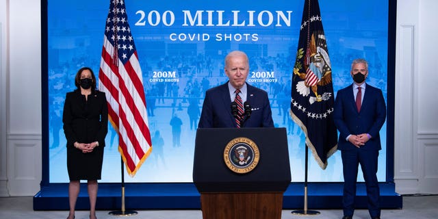 President Biden speaks alongside former White House COVID-19 response coordinator Jeff Zients and Vice President Kamala Harris on April 21, 2021.