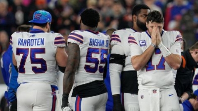 Buffalo Bills quarterback Josh Allen (17) stands on the field as Hamlin is being treated.