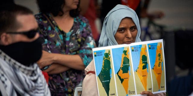 A woman holds a map of Palestine from 1946 to 2020. Supporters of Palestine organized a gathering in Toulouse against the planned annexation of parts of West Bank and the total annexation of the Jordan Valley by Netanyahu government on July 1, 2020. 