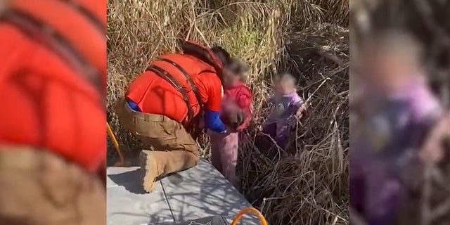 Still image from a video released by the Mexican National Institute of Migration showing the rescue of three sisters abandoned at the border.