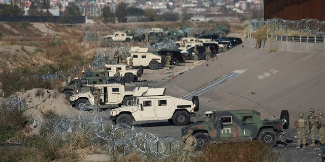 FILE: U.S. military guard El Paso's border with Mexico, seen from Ciudad Juarez, Mexico, Tuesday, Dec. 20, 2022.