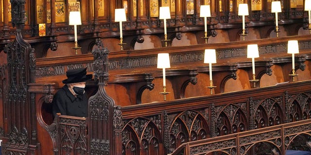 Britain's Queen Elizabeth II sits alone in St. George's Chapel during the funeral of Prince Philip at Windsor Castle, Windsor, England, April 17, 2021. (Jonathan Brady/Pool via AP, File)