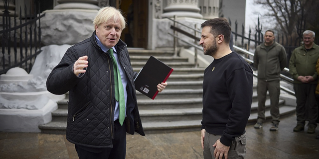 Ukrainian President Volodymyr Zelenskyy, right, and former British Prime Minister Boris Johnson talk during their meeting in Kyiv, Ukraine, on Sunday, Jan. 22.