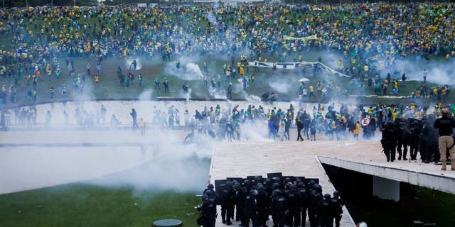 Supporters of former Brazilian President Jair Bolsonaro demonstrate against President Luiz Inacio Lula da Silva as security forces operate, outside Brazil’s National Congress in Brasilia, Brazil, Jan. 8, 2023. 