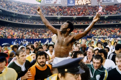 Pelé holds Brazilian and American flags after his final match in 1977. It was an exhibition at Giants Stadium between the Cosmos and his longtime Brazilian club, Santos. He played the first half for the Cosmos and the second half for Santos.