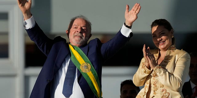 President Luiz Inacio Lula da Silva, left, waves to supporters beside his wife Rosangela Silva after he was sworn in as new president at the Planalto Palace in Brasilia, Brazil, Sunday, Jan. 1, 2023. 