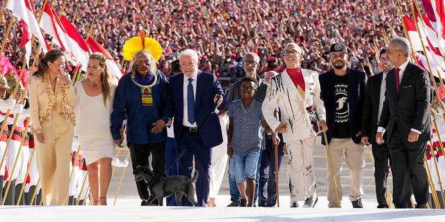 Luiz Inacio Lula da Silva arrives to the Planalto Palace with a group representing diverse segments of society after he was sworn in as new president in Brasilia, Brazil, Sunday, Jan. 1, 2023. 