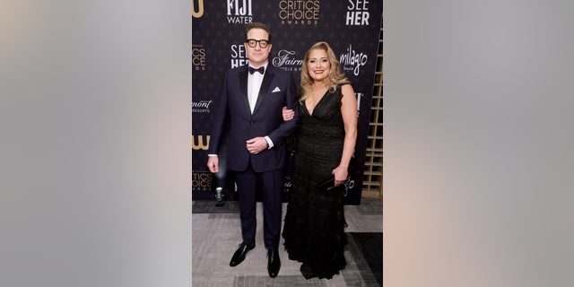 Brendan Fraser and Jeanne Moore smile while attending Critics Choice Awards.
