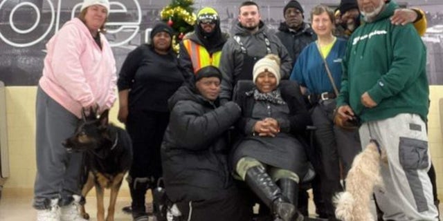 Jay Withey, center, is pictured surrounded by some of the people he helped find shelter from the deadly winter storm in Western New York last weekend. 