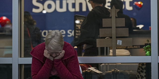 A traveler waits outside the Southwest Airlines baggage office at Oakland International Airport in Oakland, California on Wednesday.