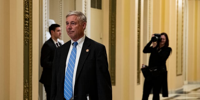 Rep. Fred Upton (R-MI) pays his respects over the flag-draped casket of U.S. Rep. Elijah Cummings (D-MD) as Cummings lies in state outside of the House Chamber in the Will-Rodgers corridor of the U.S. Capitol October 24, 2019, in Washington, D.C.