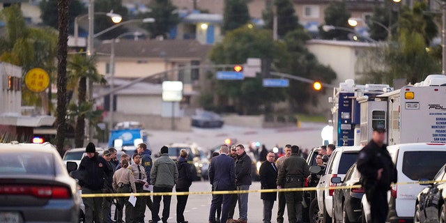 Law enforcement personnel gather outside a ballroom dance club in Monterey Park, Calif., Sunday, Jan. 22, 2023. 