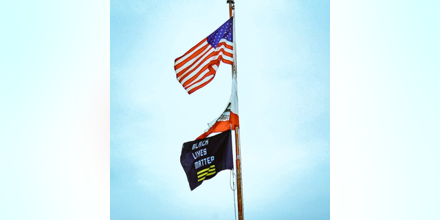 FILE- Black Lives Matter flag flies above San Diego Unified Central Office in February 2021.