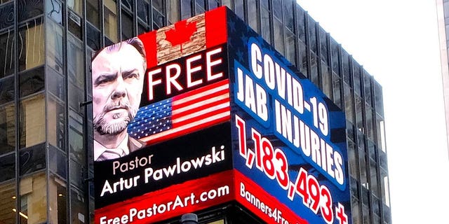 A sign in Times Square calls for the freedom of Pastor Artur Pawlowski in March 2022 while he was being imprisoned in Alberta after speaking to the trucker convoy.