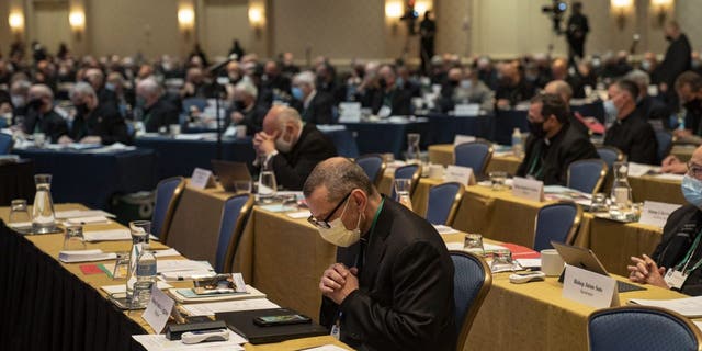Bishops gathered and had an opening prayer at a hotel banquet hall during the U.S. Conference of Catholic Bishops on Nov. 16, 2021, in Baltimore, Maryland.