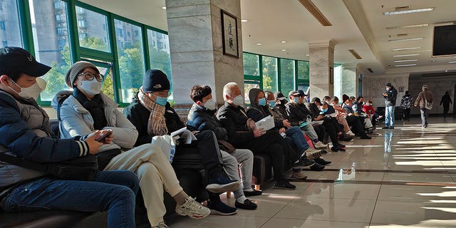 Family members of the deceased wait for the cremation procedures at a funeral home in Shanghai, China on Jan. 4, 2023. China on Saturday, Jan. 14, reported nearly 60,000 deaths in people who had COVID-19 since early December following complaints the government was failing to release data about the status of the pandemic. (Chinatopix Via AP)