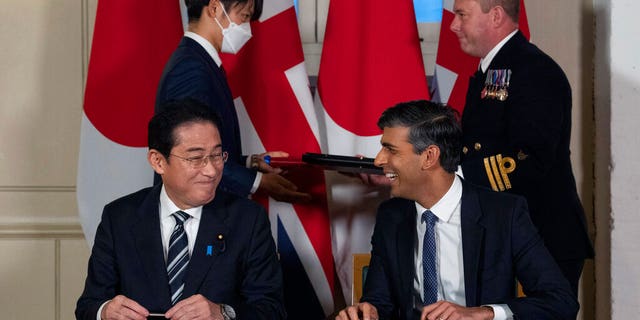 Britain's Prime Minister Rishi Sunak smiles at Japan's Prime Minister Fumio Kishida after they signed a defense agreement at the Tower of London, Wednesday, Jan. 11, 2023.