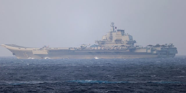 Chinese aircraft carrier Liaoning sails through the Miyako Strait near Okinawa on their way to the Pacific in this handout photo taken by Japan Self-Defense Forces in 2021. China has been operating near Japan in recent weeks, worrying Japanese defense officials.