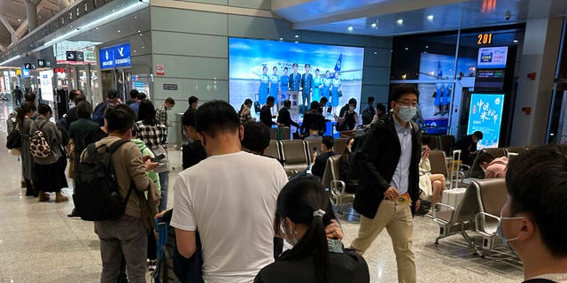 Passengers prepare to board a flight at the airport in north-central China's Jiangxi province.