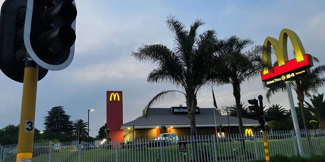 While the traffic lights are out in Johannesburg due to power cuts, a McDonald's restaurant operates on a generator. Critics accuse the current South African president of hypocrisy over his family's ownership and operation of the country's McDonald's franchise.