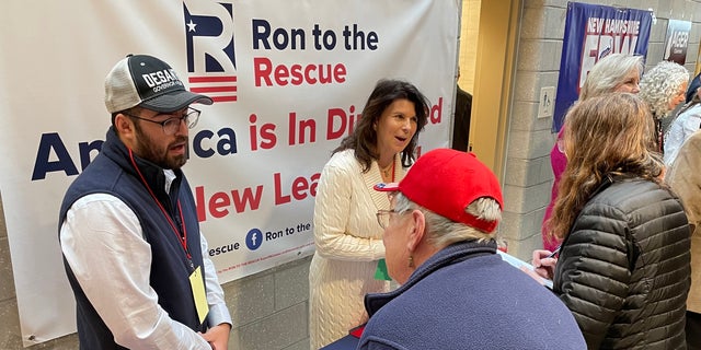 The Ron to the Rescue table at the New Hampshire GOP annual meeting is manned by Alex Olson, a senior adviser for the super PAC, and by former state GOP vice chair Pam Tucker, in Salem on Jan 28, 2023.