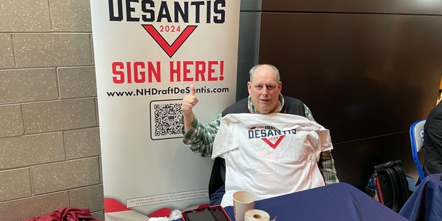 Republican activist Chris Wood mans the Draft DeSantis table at the New Hampshire GOP annual meeting in Salem on Jan. 28, 2023.