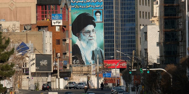 A huge mural of Ayatollah Seyyed Ali Khamenei Iran's Supreme Leader painted next to a smaller one of Ayatollah Ruhollah Khomeini, right, seen on Motahari street on March 8, 2020 in Tehran, Iran. The message on the wall reads, "The power and influence and dignity of America in the world is on the fall and extermination" and on top of the building, another slogan reads "We are standing till the end."