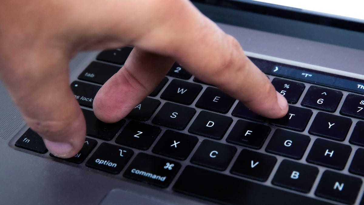 A hand on a keyboard using the CTRL+Shift+T shortcut.