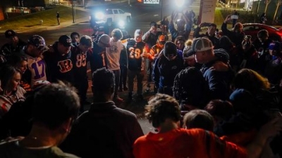 Fans gather outside the University of Cincinnati Medical Center in Cincinnati, where Buffalo Bills' Damar Hamlin was taken after collapsing on the field during an NFL football game against the Cincinnati Bengals Monday night.