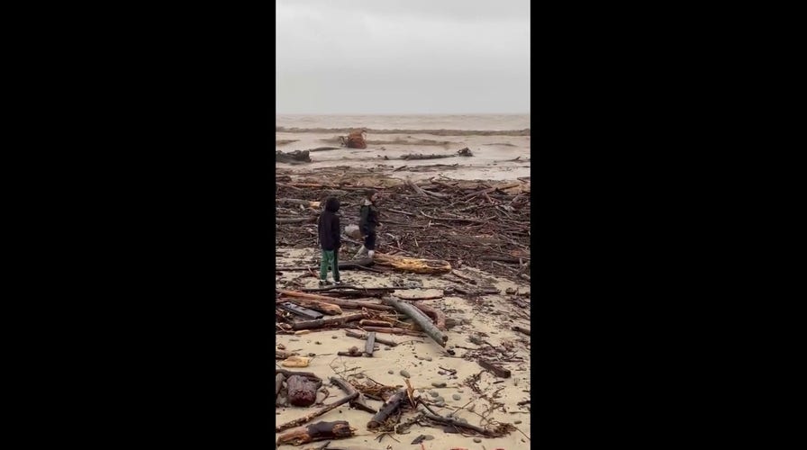 California beach littered with debris as storms caused widespread flooding, damage 