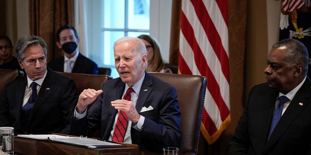 Flanked by Secretary of State Antony Blinken, left, and Secretary of Defense Lloyd Austin, right, President Biden speaks during a cabinet meeting in the Cabinet Room of the White House Jan. 5, 2023, in Washington, D.C. 