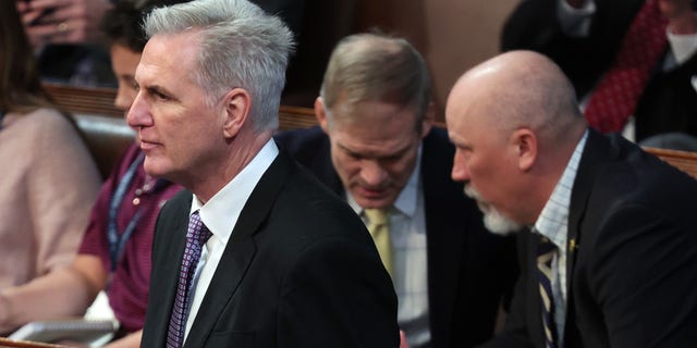 House Republican Leader Kevin McCarthy, R-Calif., arrived in the House chamber for the second day of elections for Speaker of the House as Rep.-elect Jim Jordan, R-Ohio, talked to Rep.-elect Chip Roy, R-Texas.