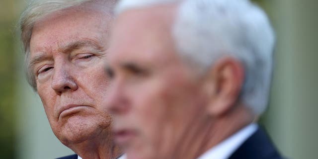 President Donald Trump listens as Vice President Mike Pence answers questions during the daily briefing of the coronavirus task force at the White House in 2020.