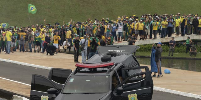 A view of damaged police car as supporters of former President Jair Bolsonaro clash with security forces after raiding the National Congress in Brasilia, Brazil, 08 January 2023. (Joedson Alves/Anadolu Agency via Getty Images)