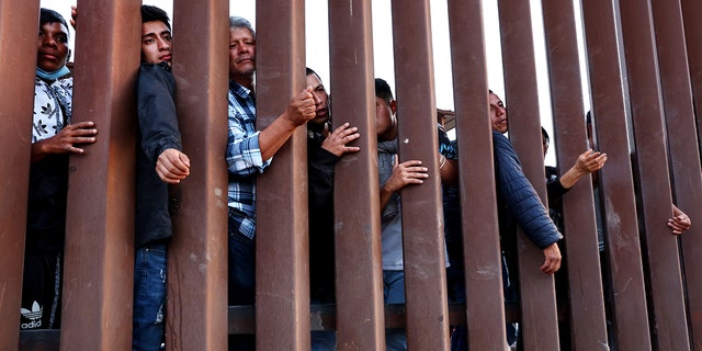 Immigrants wait for soup donated by the Yuma County Abolition group after crossing the border from Mexico on May 23, 2022 in San Luis, Arizona. 