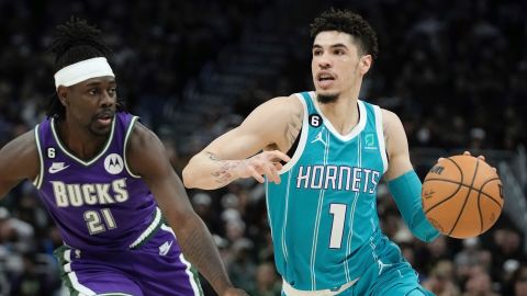 LaMelo Ball goes past Milwaukee Bucks' Jrue Holiday during the first half. 