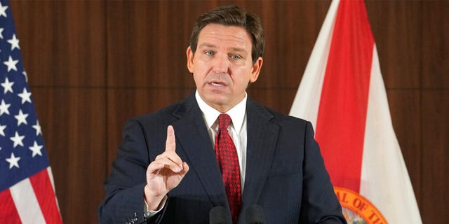 FILE: Florida Gov. Ron DeSantis gestures during a news conference, Thursday, Jan. 26, 2023, in Miami. DeSantis on Tuesday, Jan. 31, 2023, announced plans to block state colleges from having programs on diversity, equity and inclusion, and critical race theory.