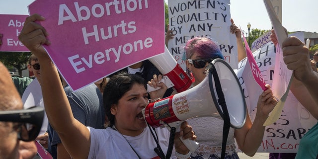 A group of anti-abortion protesters crashes the Women's March Action Rally for Reproductive Rights at Mariachi Plaza in Los Angeles, California, on Oct. 8, 2022.