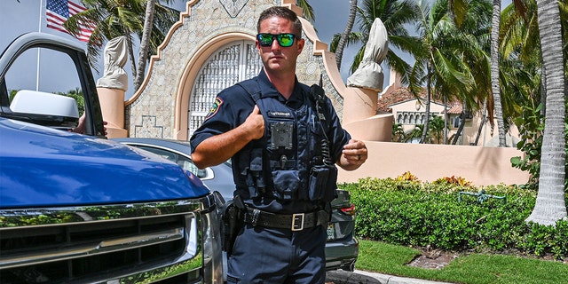Local law enforcement officers are seen in front of the home of former President Donald Trump at Mar-A-Lago in Palm Beach, Florida on Aug. 9, 2022.