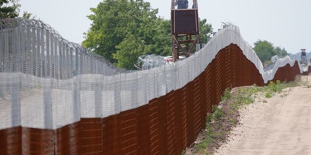 Hungarian soldiers patrol the Hungarian-Serbian border near the village of Tompa, Hungary, June 14, 2017.