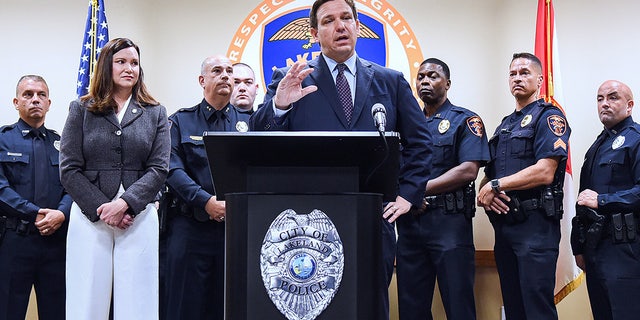 Florida Attorney General Ashley Moody looks on as Gov. Ron DeSantis speaks at a press conference at the Lakeland Police Department in September 2021.