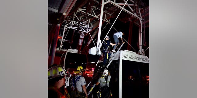 Orange County Fire Rescue firefighters rescue riders from ICON Park's Ferris wheel after a power failure.