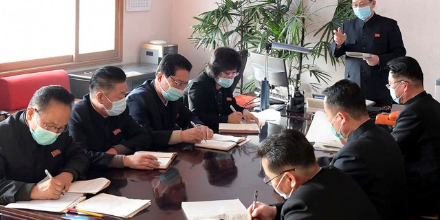 In this undated photo distributed Feb. 12, 2020, by the North Korean government, North Korean Premier Kim Jae-ryon, right top, has a meeting at the emergency anti-epidemic headquarters in Pyongyang, North Korea. 