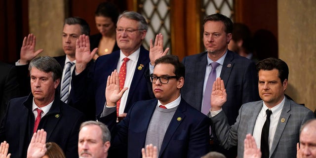Rep. George Santos, R-N.Y., and Rep. Matt Gaetz, R-Fla., are sworn in by Speaker of the House Kevin McCarthy of Calif., as members of the 118th Congress in Washington, early Saturday, Jan. 7, 2023. 