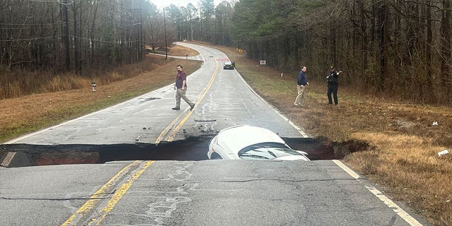Images captured by the Athens-Clarke County Police show a vehicle fall into a break in the road.