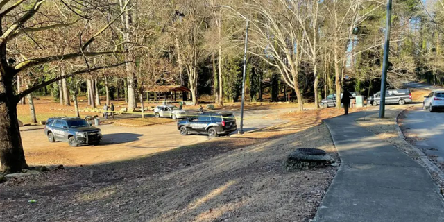 A Georgia woman walking her dog at a park in Dekalb County discovered a man who had been shot to death, according to police.