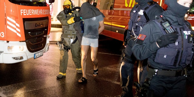 A man is taken into custody by a Special Operations Command in Castrop-Rauxel, Sunday, Jan. 8, 2023. 