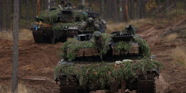Two Leopard 2A6 main battle tanks of the Bundeswehr, the German armed forces, participate in the NATO Iron Wolf military exercises on Oct. 27, 2022, in Pabrade, Lithuania.