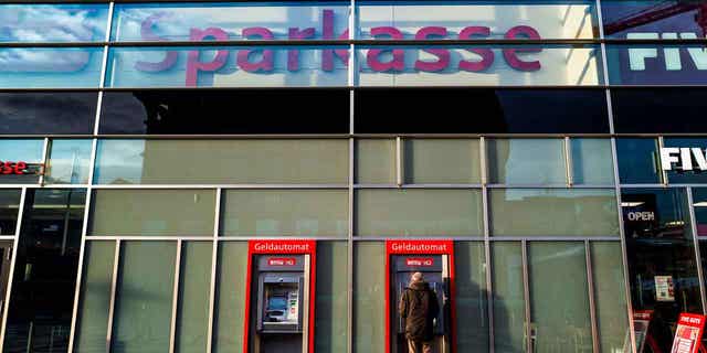 A man uses an ATM at a bank in Berlin, Germany, on Dec. 26, 2022. Germany recorded its highest annual inflation rate in more than 70 years in 2022.