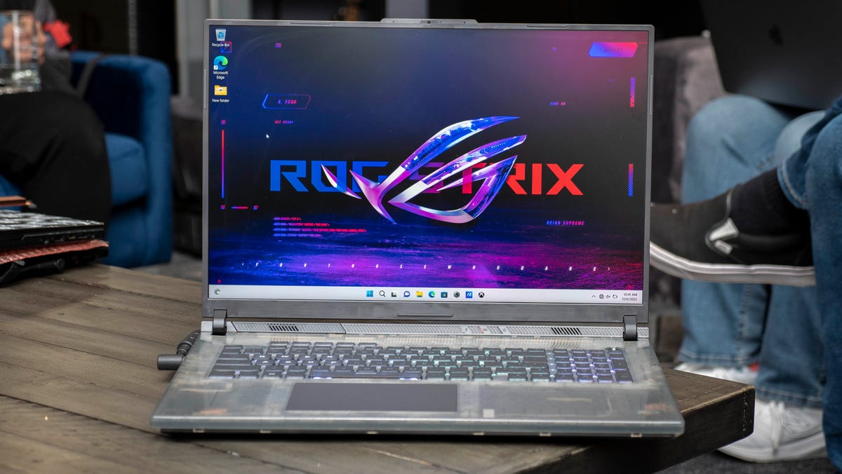 ROG Strix SCAR 18 gaming laptop sitting on a wood table.